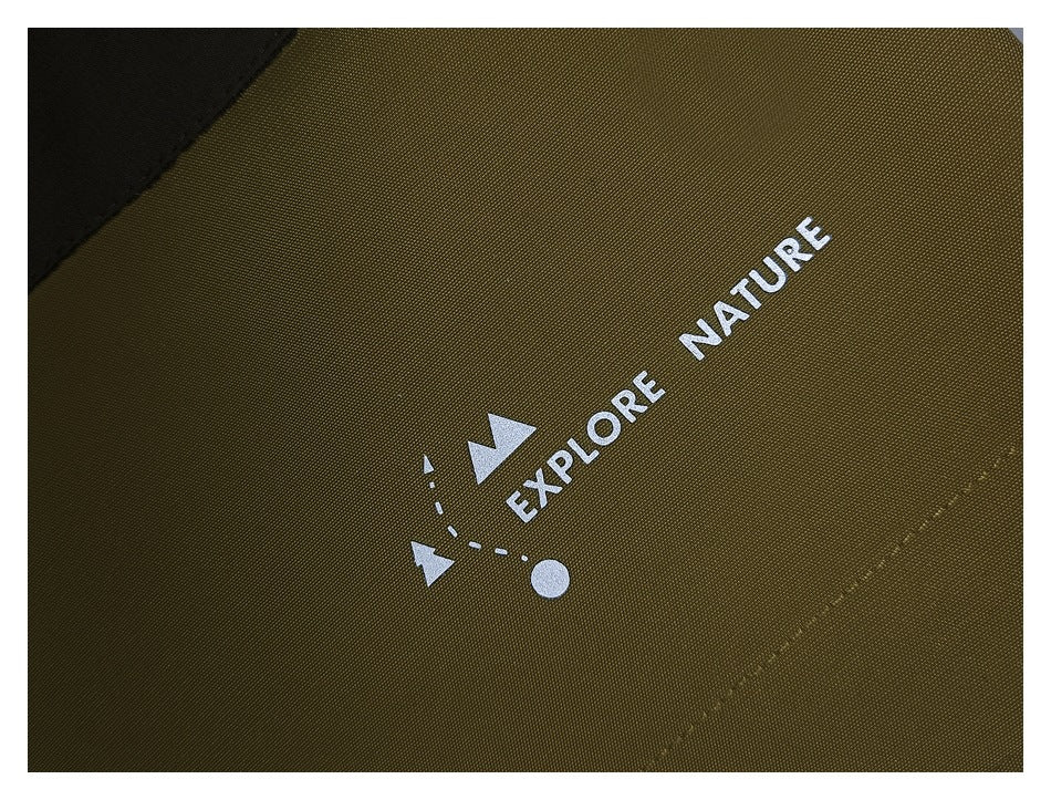 Close-up of dark olive garment fabric with a white “Explore Nature” print and a black panel.