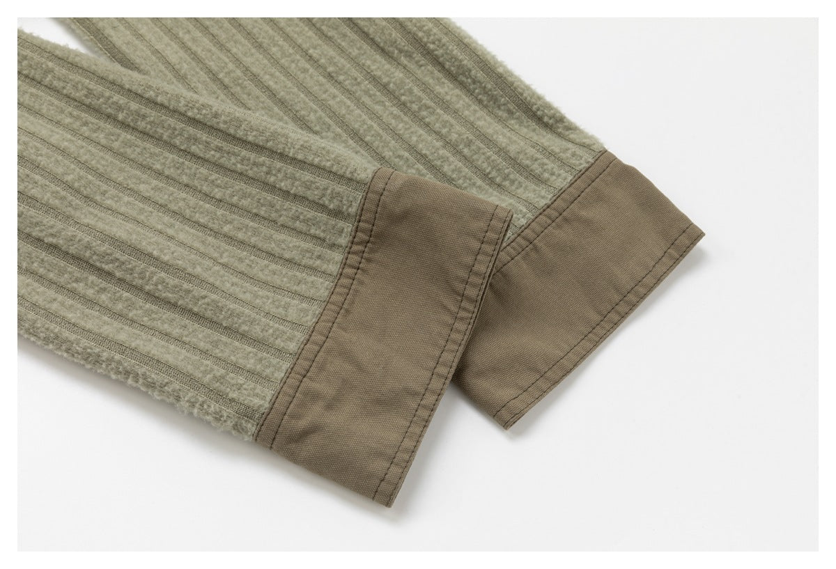 Close-up of the jacket sleeve cuff with a wide taupe fabric band and striped panel.