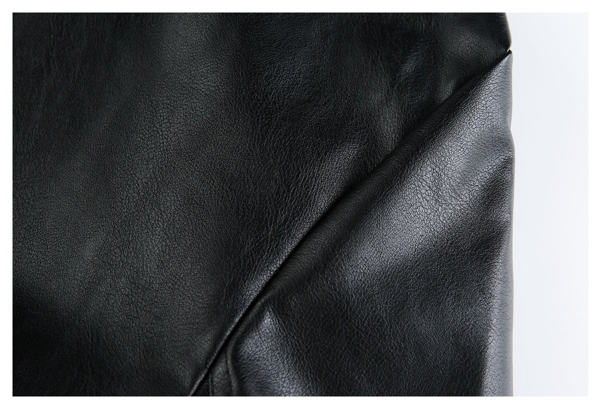 Close-up of black pebbled material with a folded edge and subtle sheen.