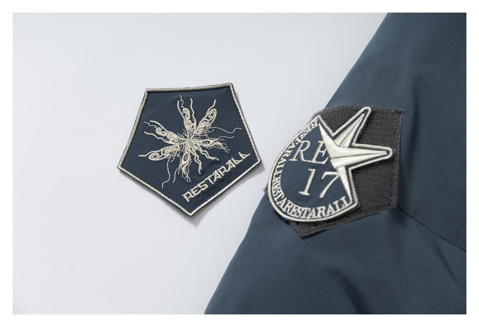 Embroidered patches with lettering and a star shown beside a dark jacket.