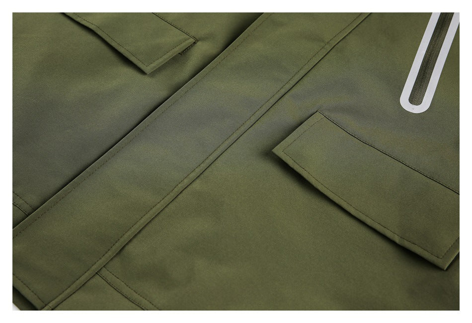 Olive garment close-up showing overlapping panels, rectangular tabs, and a white outlined accent.