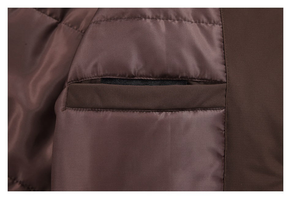 Close-up of a dark brown jacket pocket opening with a strip of black fastening material.