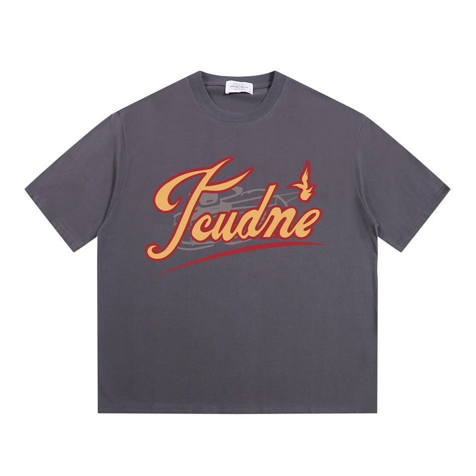 Gray crew neck T-shirt flat lay with yellow and red retro script graphic on the chest