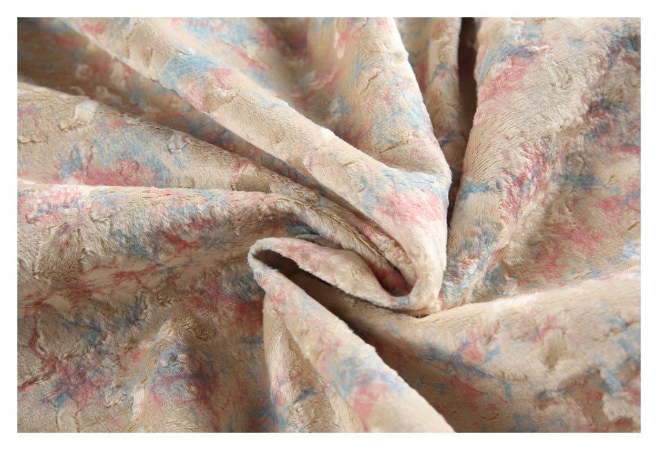 Close-up of the jacket's plush cream fabric with irregular pink and blue patterning.