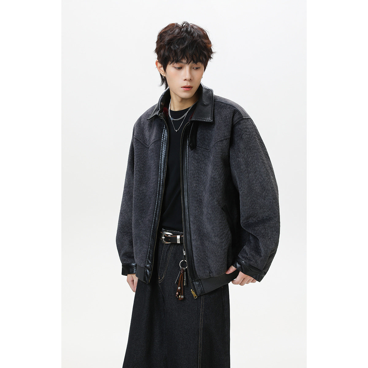 Model wearing an open dark charcoal textured jacket with a black collar and trim.