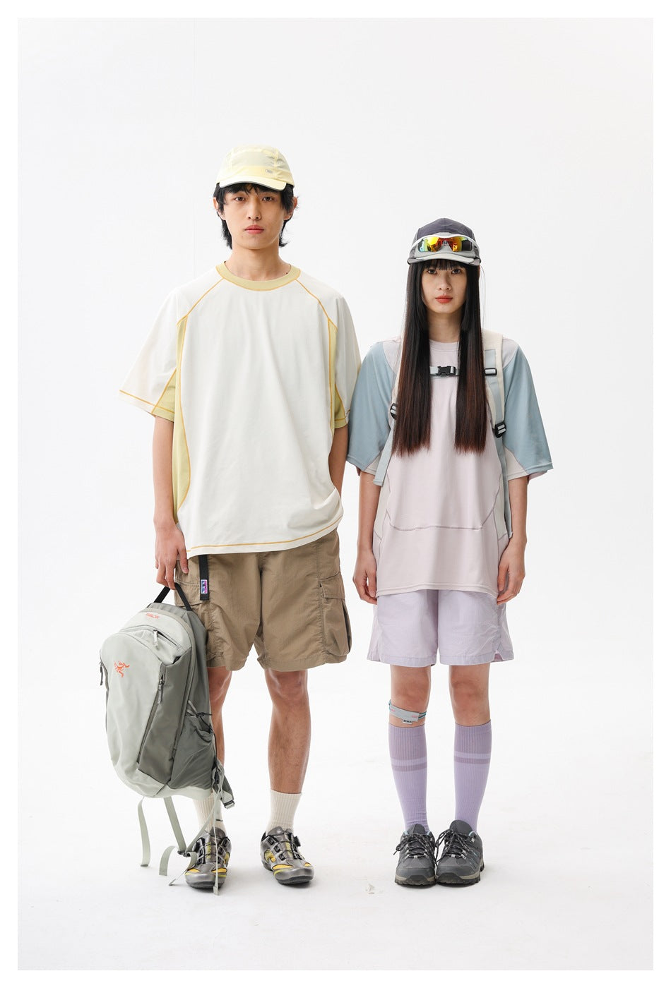 Two models show outdoor outfits: one in a white and pale yellow top with beige shorts, the other in a pale pink top with blue