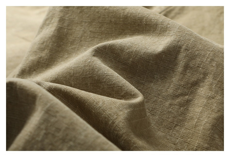 Macro view of textured tan fabric gathered into soft folds.