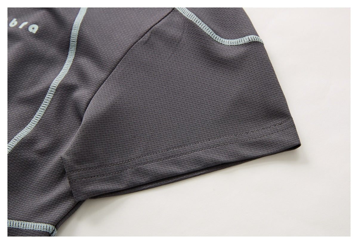 Close-up of a charcoal short sleeve with a stitched hem and pale blue seam detail.