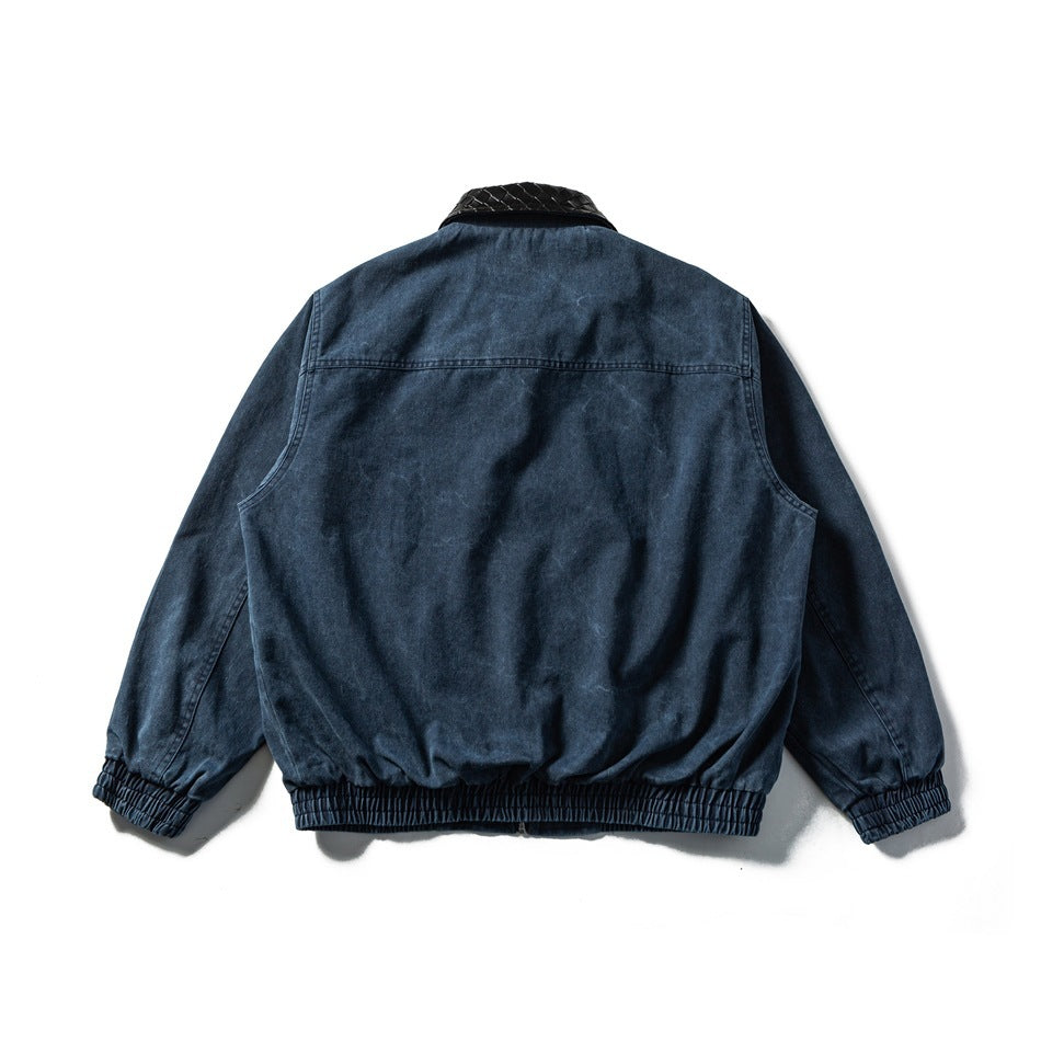 Back view of a dark blue jacket with a black woven-texture collar and gathered cuffs and hem.