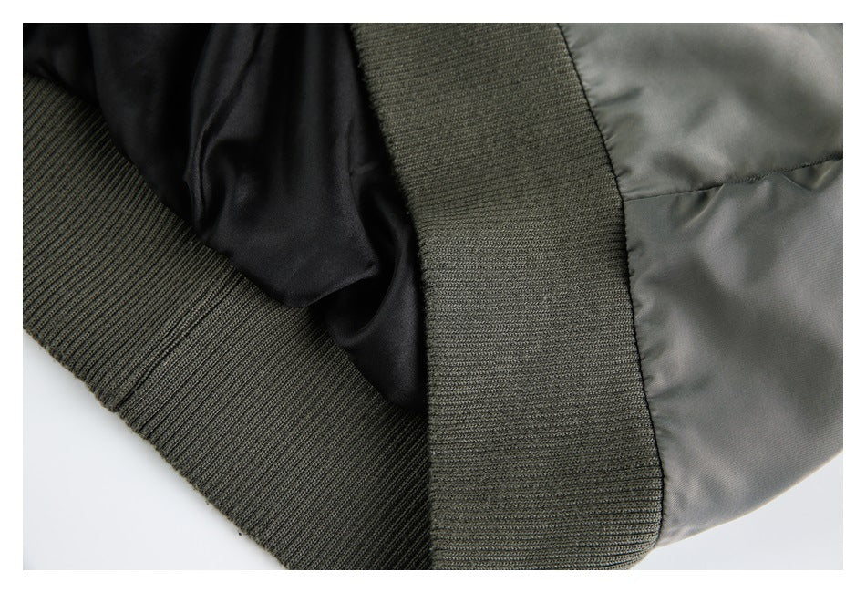 Close-up of the gray jacket's black lining and wide dark rib-knit hem and cuff.