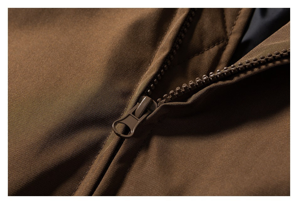 Close-up of a brown jacket's open zipper and pull.