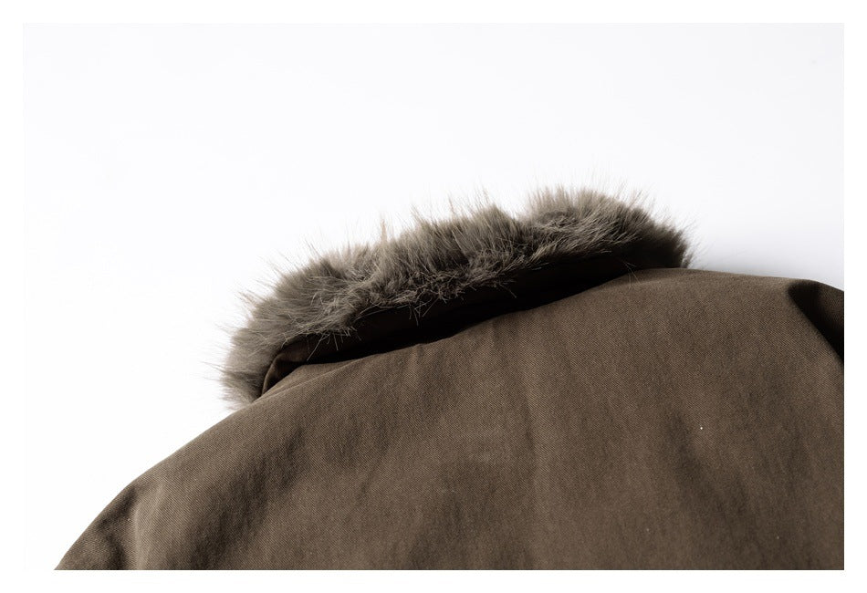 Close-up of a brown garment hood edged with gray fur trim.