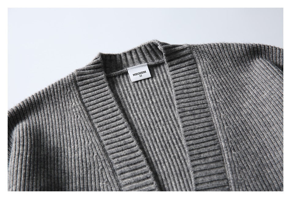 Close-up of a gray rib-knit cardigan neckline and wide ribbed front band, with a small NEOSISM size M label.
