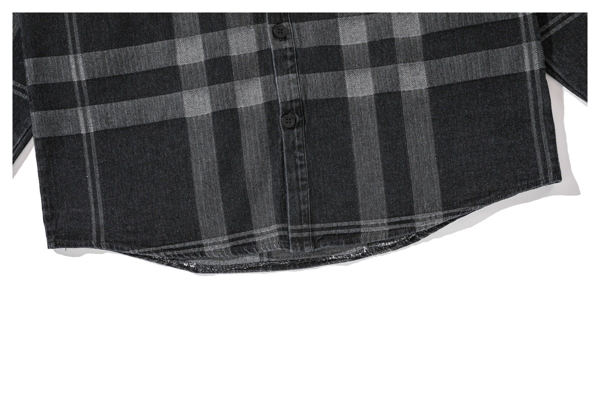 Close-up of the charcoal plaid shirt's lower front and curved hem.