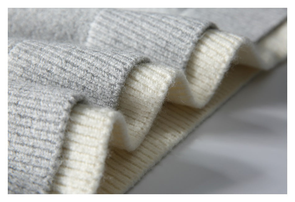 Close-up of gray and cream ribbed garment trim and knit edges.