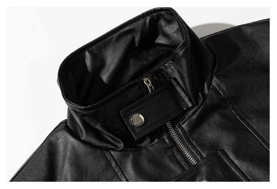 Close-up of the black jacket's stand collar, zipper, and snap-tab fastening.