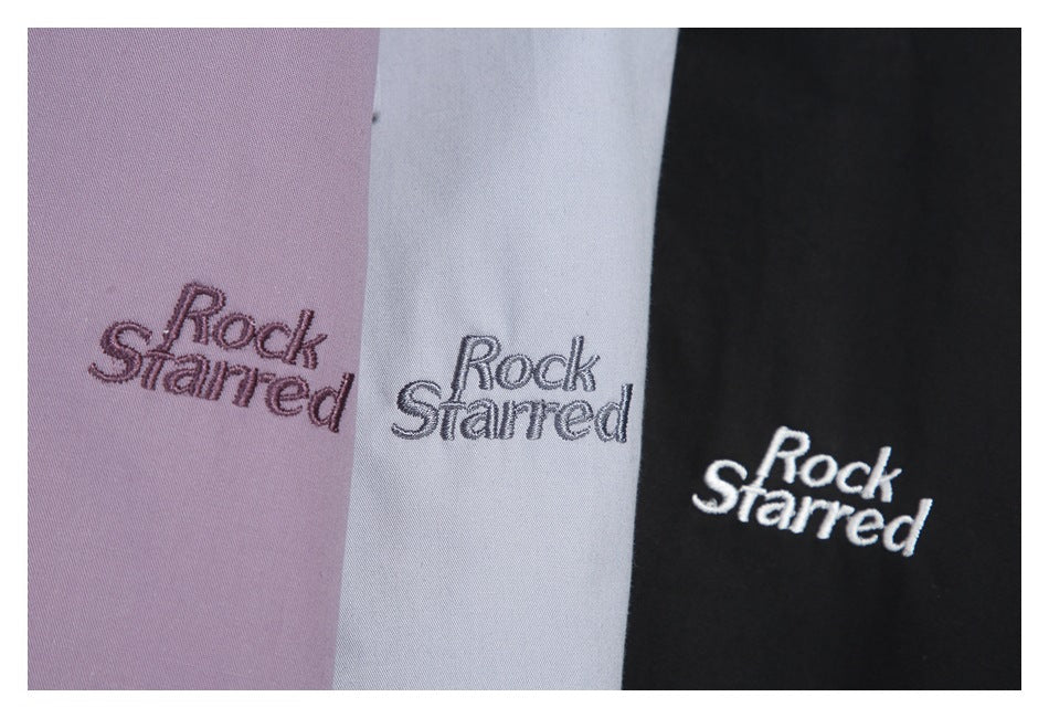 Three fabric colorways—lavender, pale gray, and black—each embroidered with “Rock Starred.”