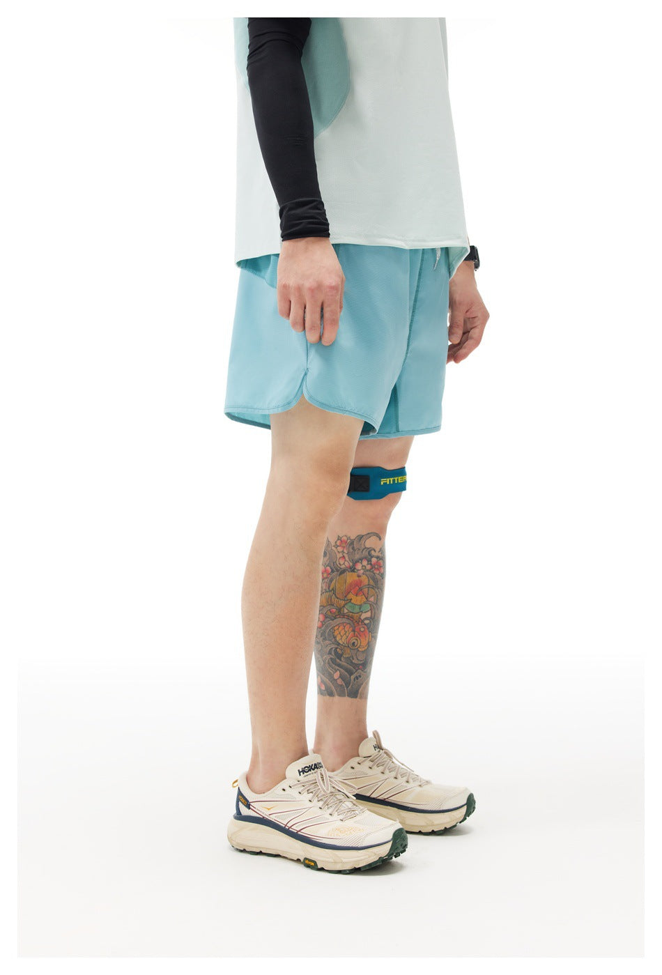 Side view of a model wearing light blue running shorts and a white shirt against a plain background.
