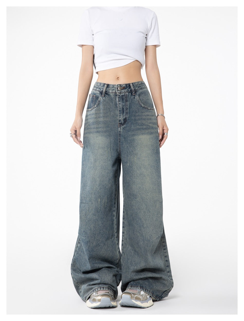 Front view of a model wearing faded blue wide-leg jeans and a white cropped T-shirt.