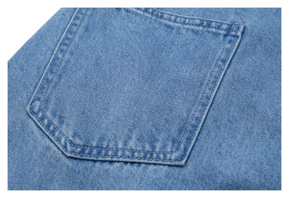 Close-up of a blue denim back pocket with visible stitching and faded texture.