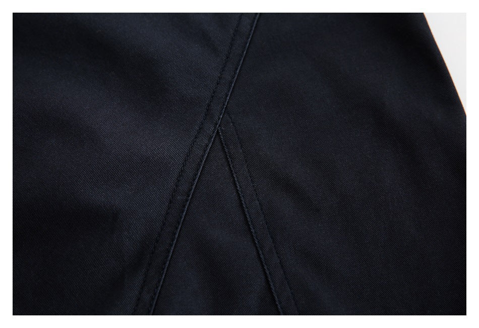 Close-up of black fabric with intersecting stitched seams.