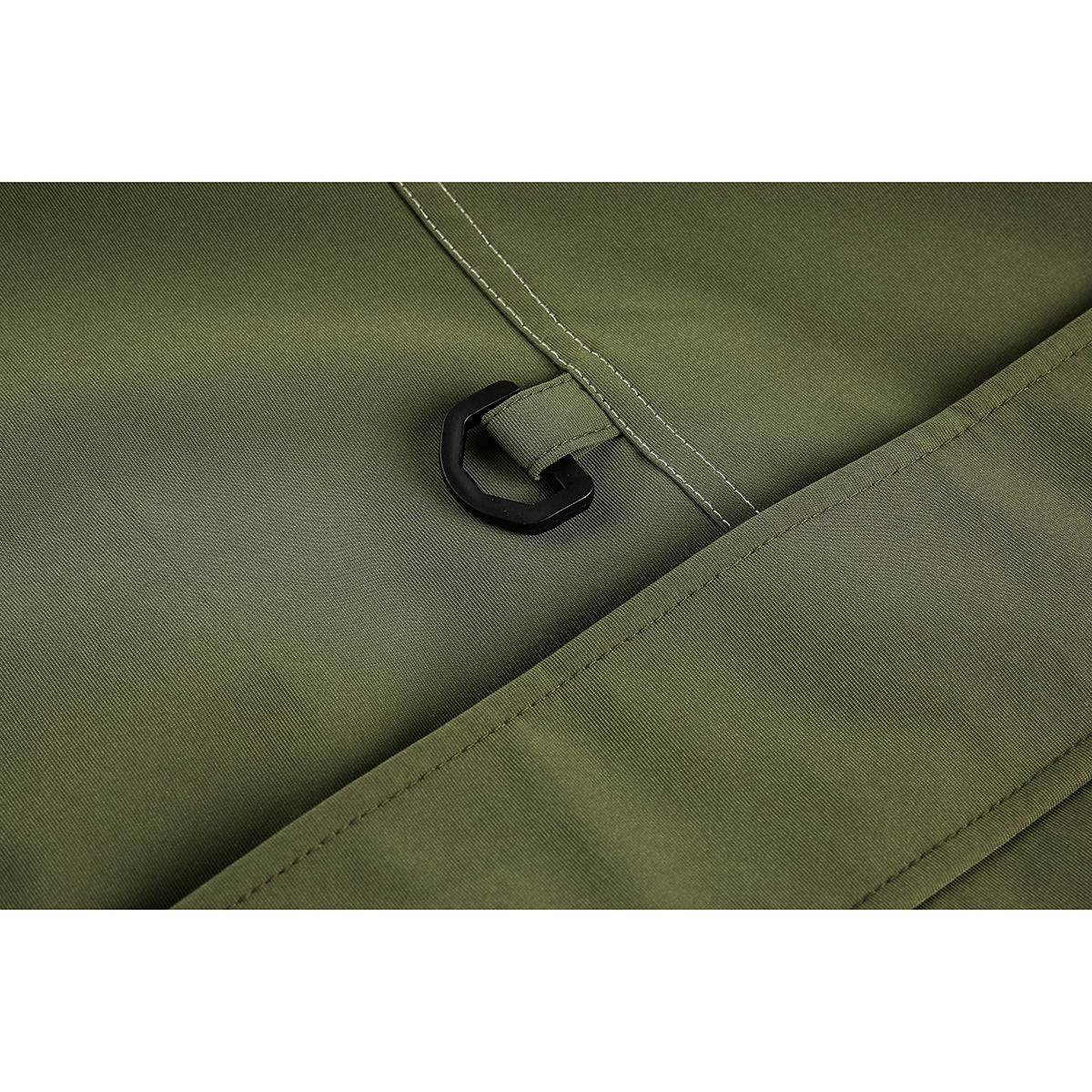 Close-up of a black plastic hook attached to a stitched tab on olive jacket fabric.
