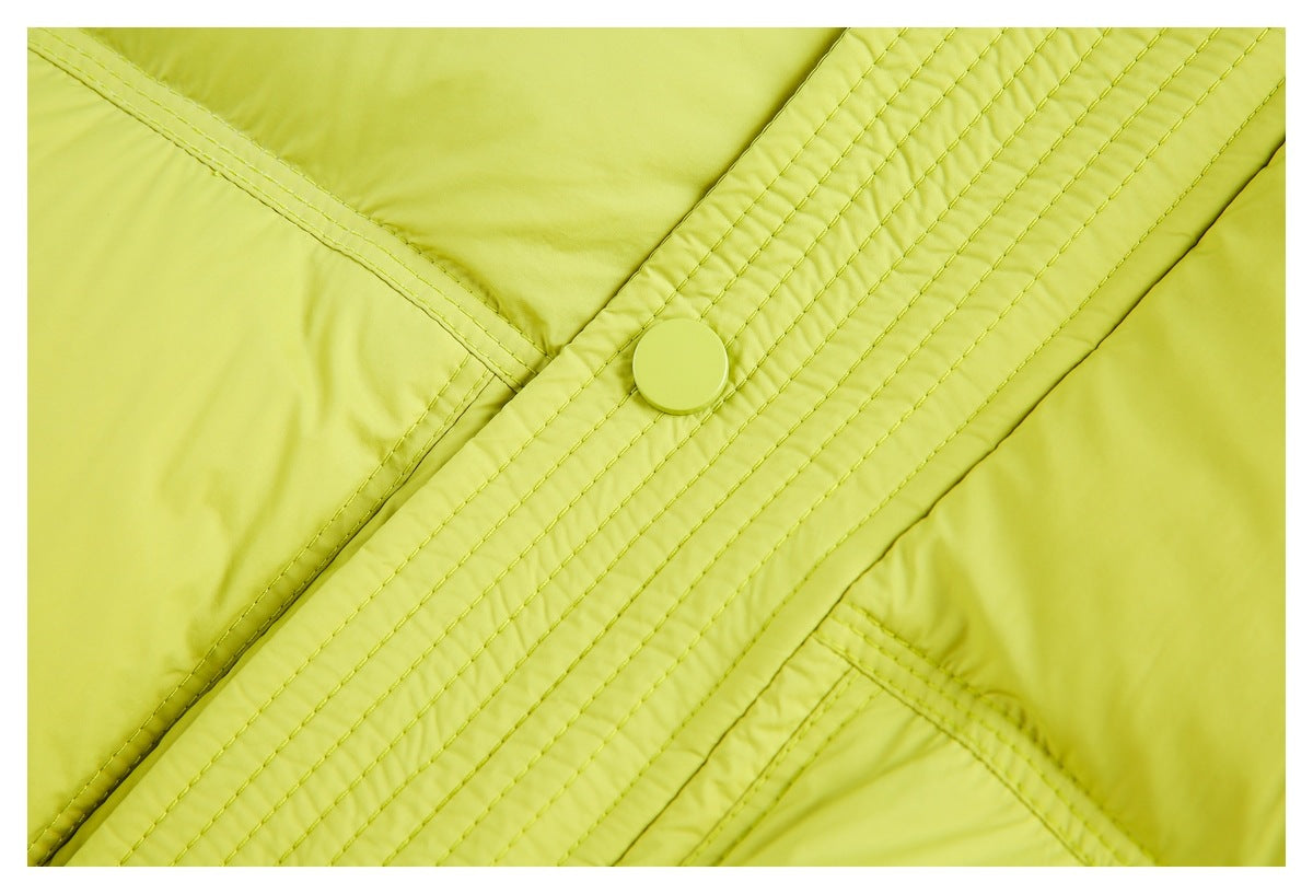 Close-up of a lime-green jacket snap fastener, stitched placket, and adjoining quilted panels.