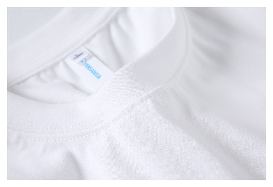 Close-up showing the ribbed crew neckline, stitching, and sewn-in label of a white T-shirt.