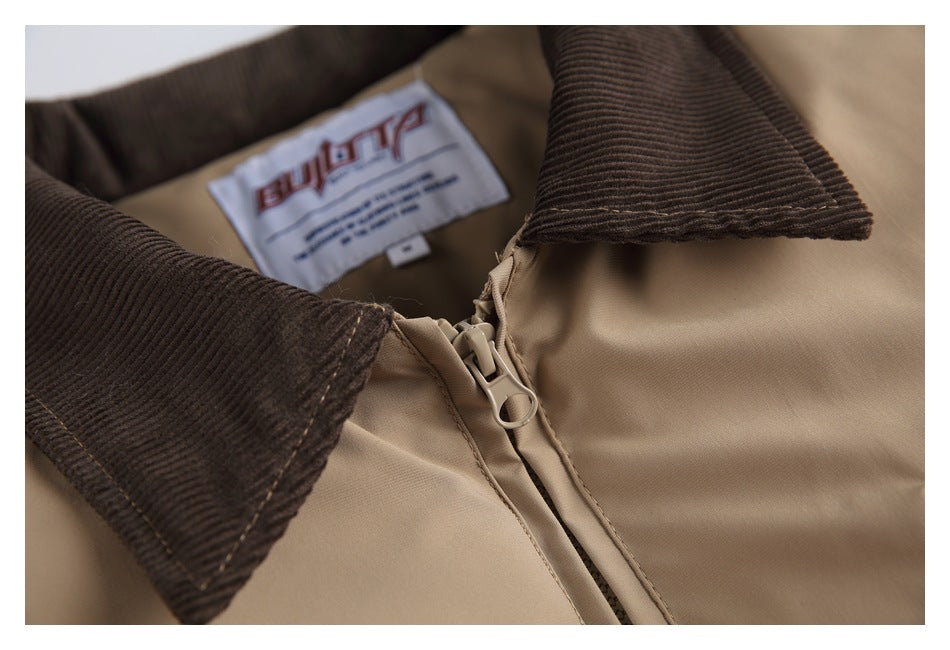 Close-up of a tan jacket's dark brown collar, front zipper and sewn neck label.