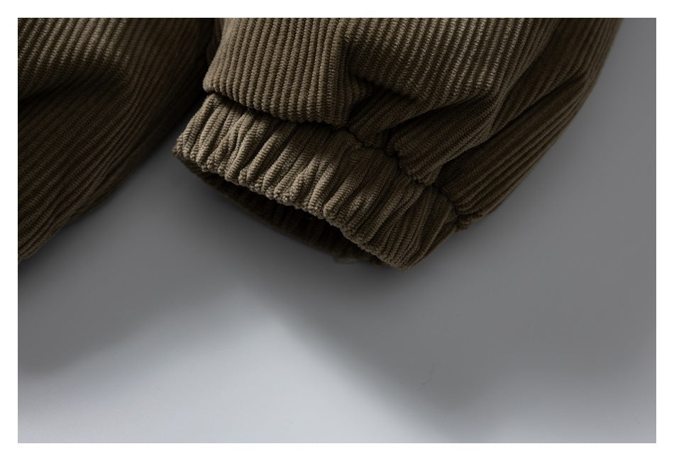 Close-up of a brown corduroy jacket sleeve with a gathered elastic cuff.