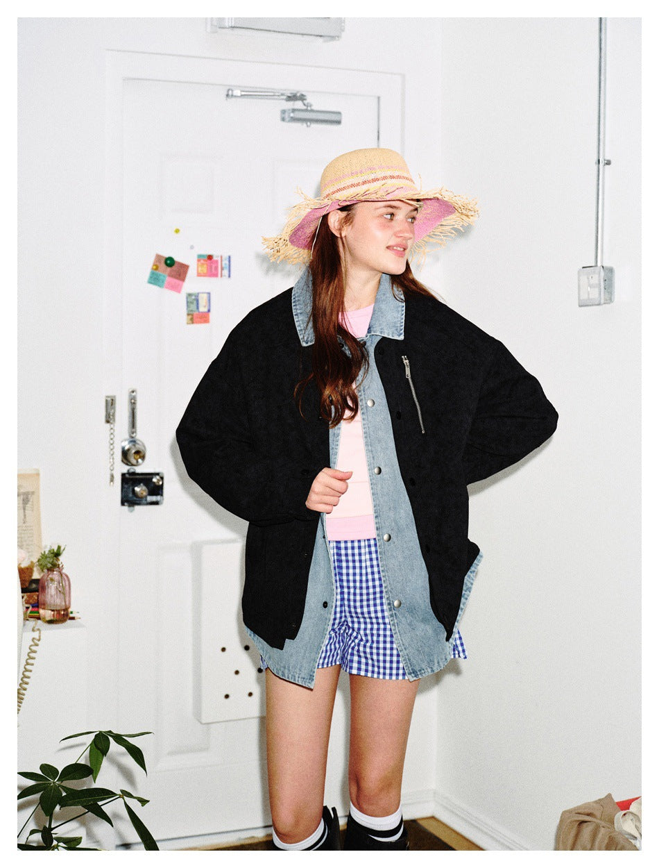 Model in a black jacket with a denim-look collar and layer, pink top, checked shorts and a straw hat, turned to the side