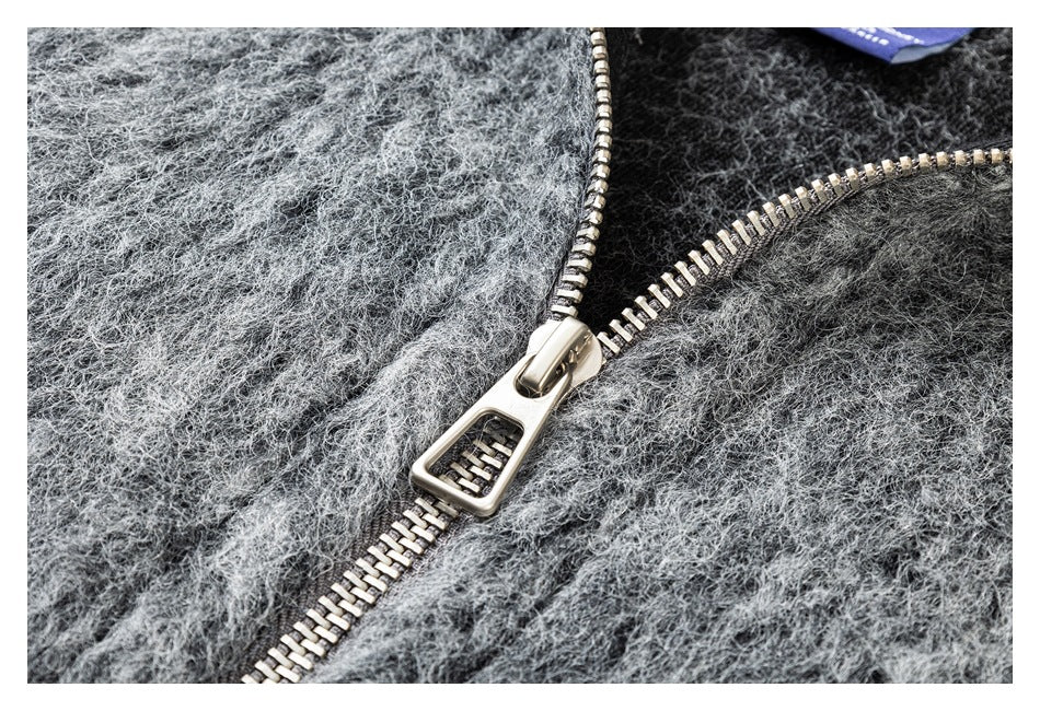 Close-up of the jacket's chunky silver zipper against fuzzy heather-gray fabric.