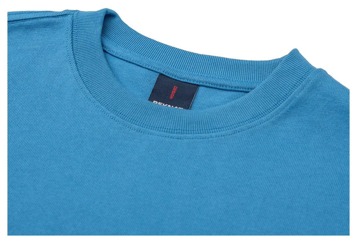 Close-up of the blue T-shirt’s ribbed crew neck, shoulder seam, and inner neck label.