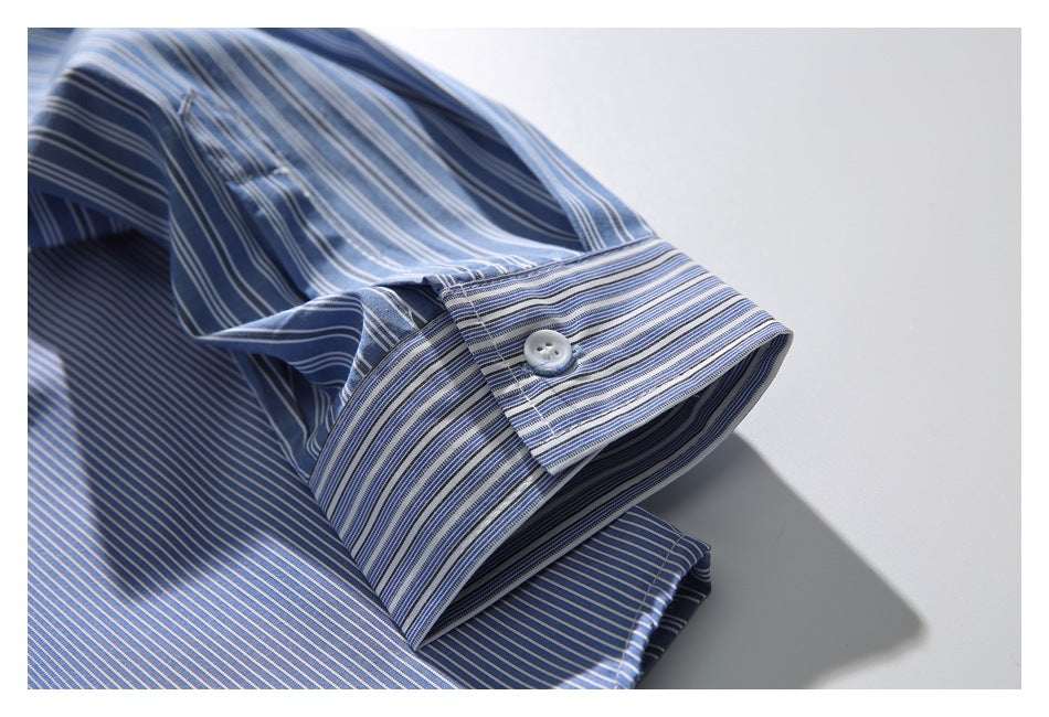 Close-up of a blue striped shirt sleeve and buttoned cuff.