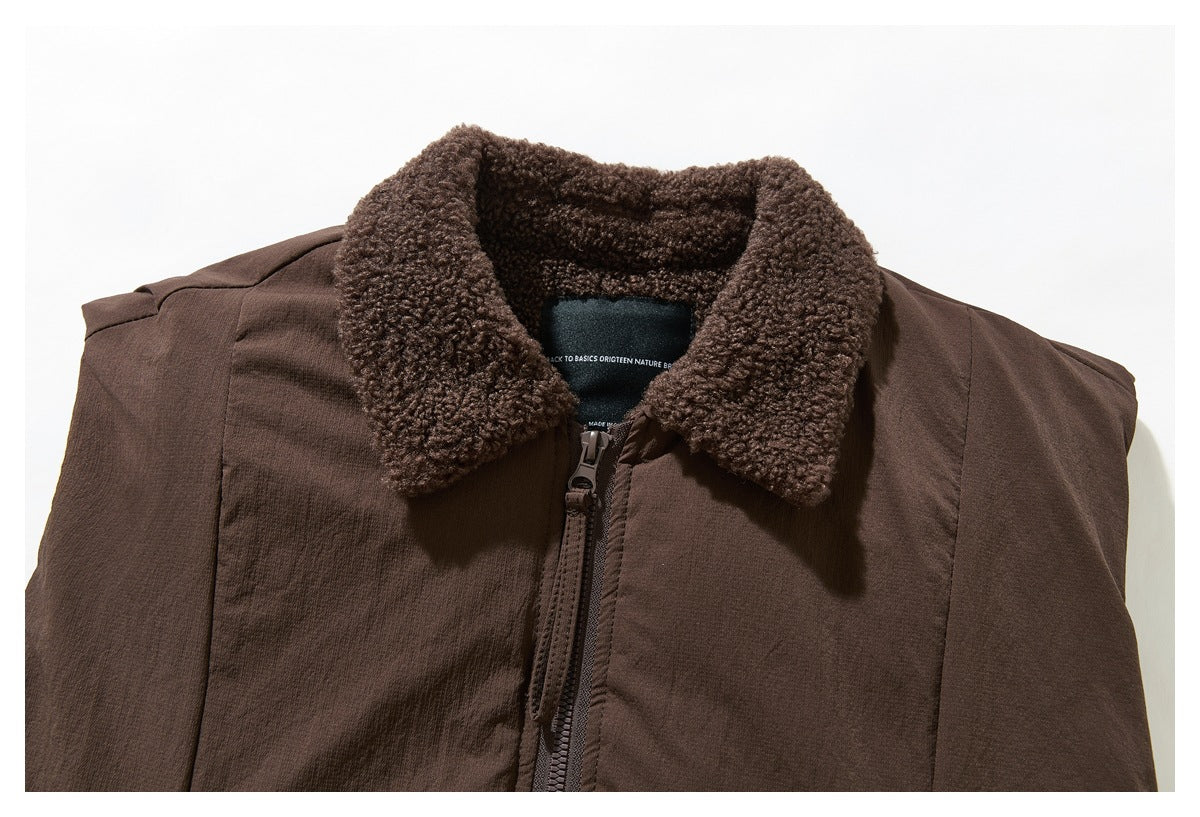 Close view of the brown jacket's textured fleece collar, upper front and central zipper.