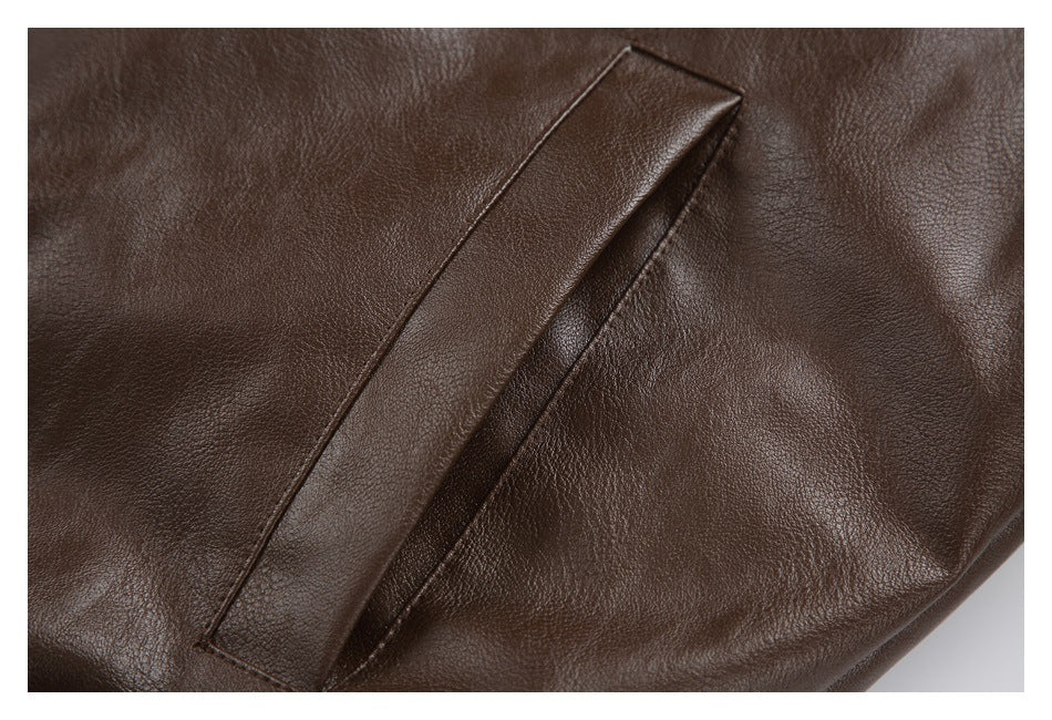 Close-up of a slanted welt pocket on a dark brown jacket.