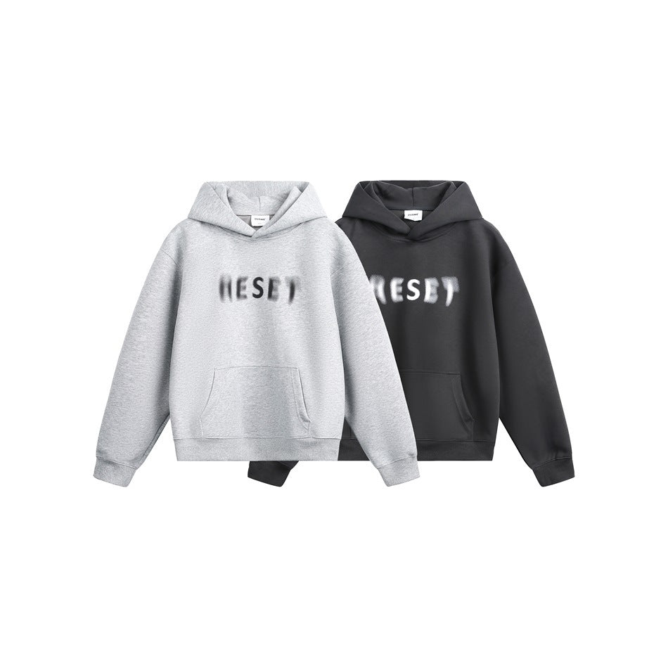 Two hoodies shown together: one light gray and one dark charcoal, both with blurred chest lettering and front pockets.