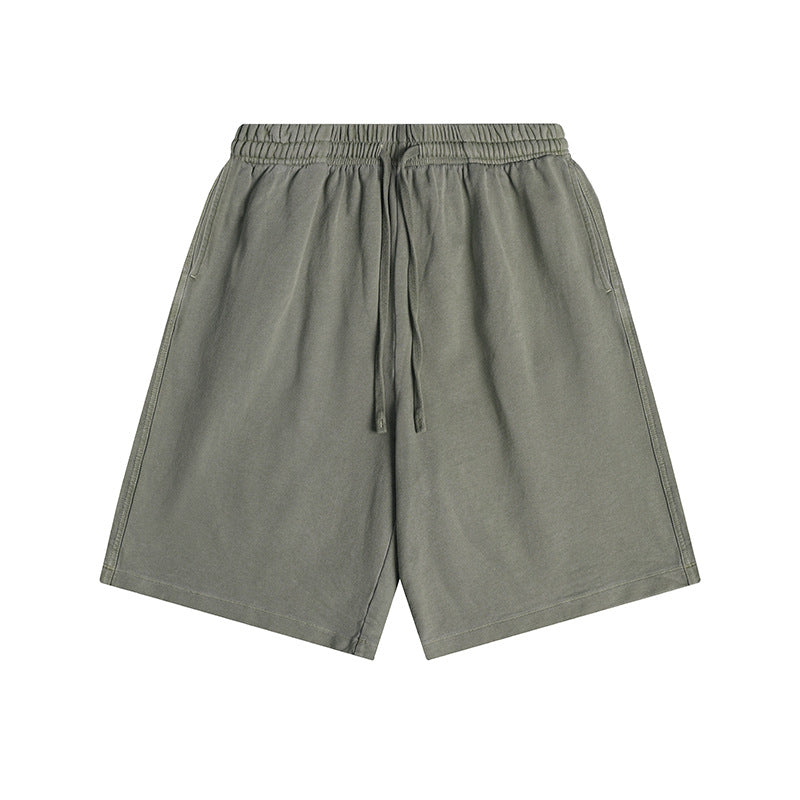 Olive green knee-length drawstring shorts with elastic waistband and side pockets, flat lay front view