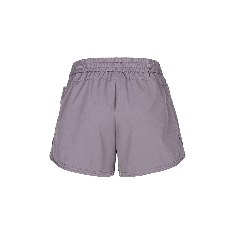 Taro purple athletic shorts back view showing elastic waistband, stitched seams and curved side hems