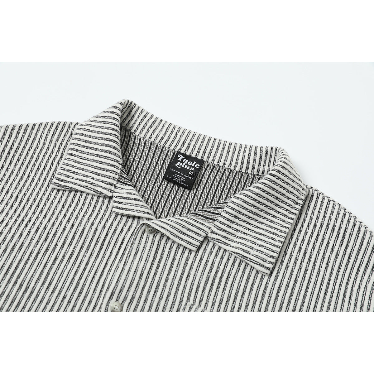 Close-up of a white shirt with narrow black stripes, showing its pointed collar, buttons, and neck label.