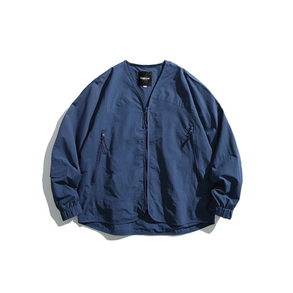 Front view of a navy zip-front jacket with a V-shaped neckline, two vertical zip pockets, and elastic cuffs.