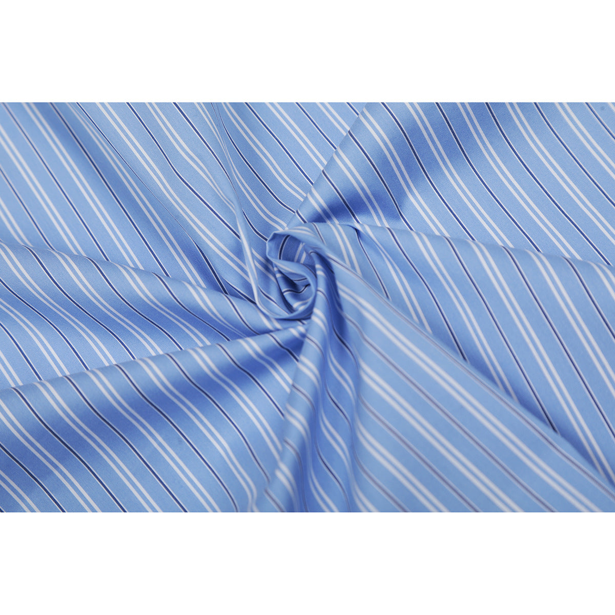 Close-up of blue fabric with narrow white and dark vertical stripes, softly gathered.