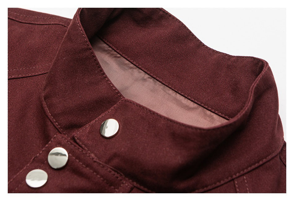 Close-up of a deep burgundy jacket collar and shiny metal snap fasteners.
