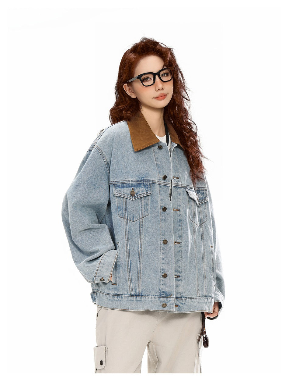 Three-quarter view of a model wearing a light-wash oversized denim jacket with a brown collar and flap chest pockets.