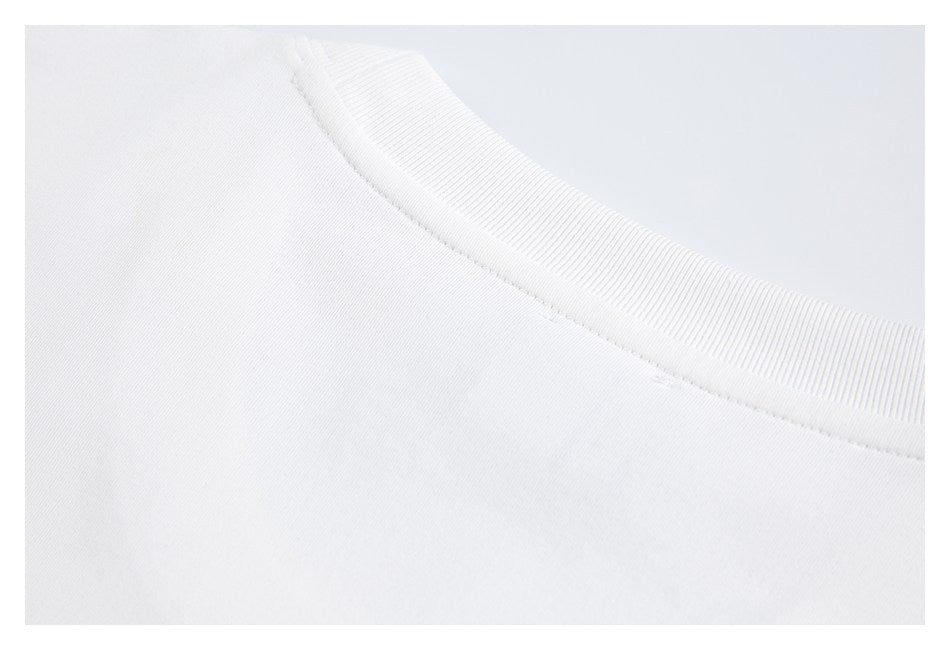 Close-up of a white shirt's ribbed crew neckline and collar seam.