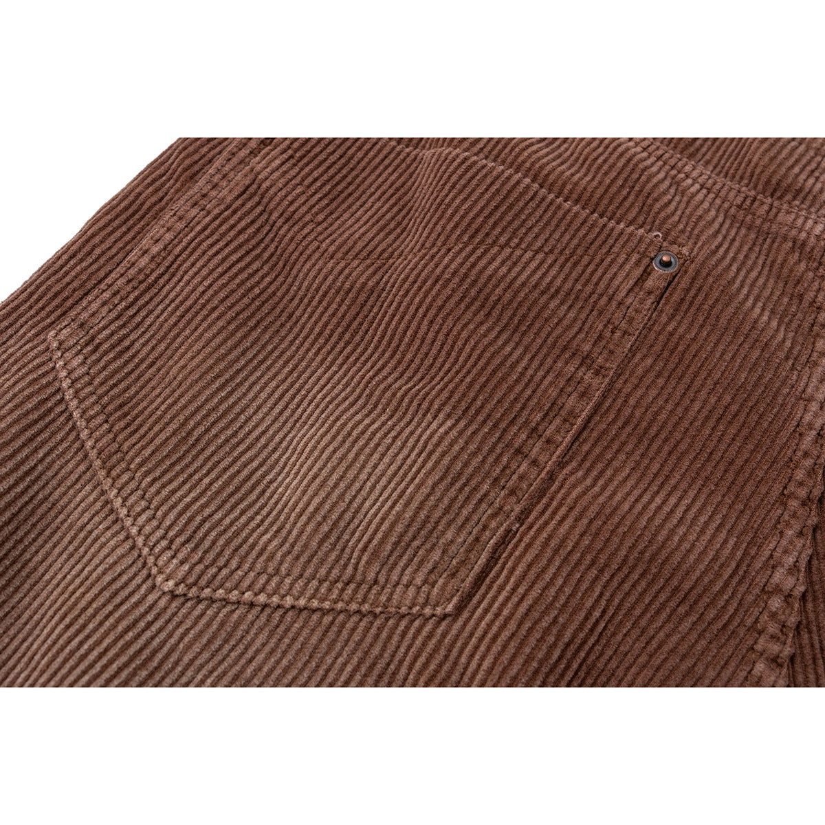 Close-up of brown corduroy shorts showing a rear pocket and its metal rivet.