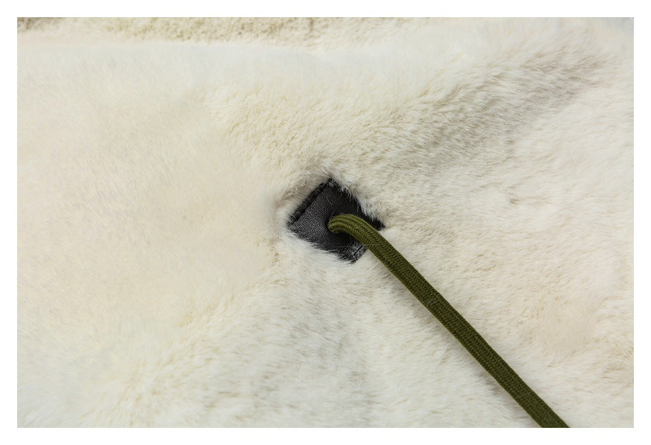 Close-up of the jacket's fluffy white lining with an olive drawcord emerging through a reinforced opening.
