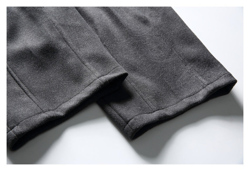 Close-up of charcoal gray trouser legs showing neatly stitched, folded hems.