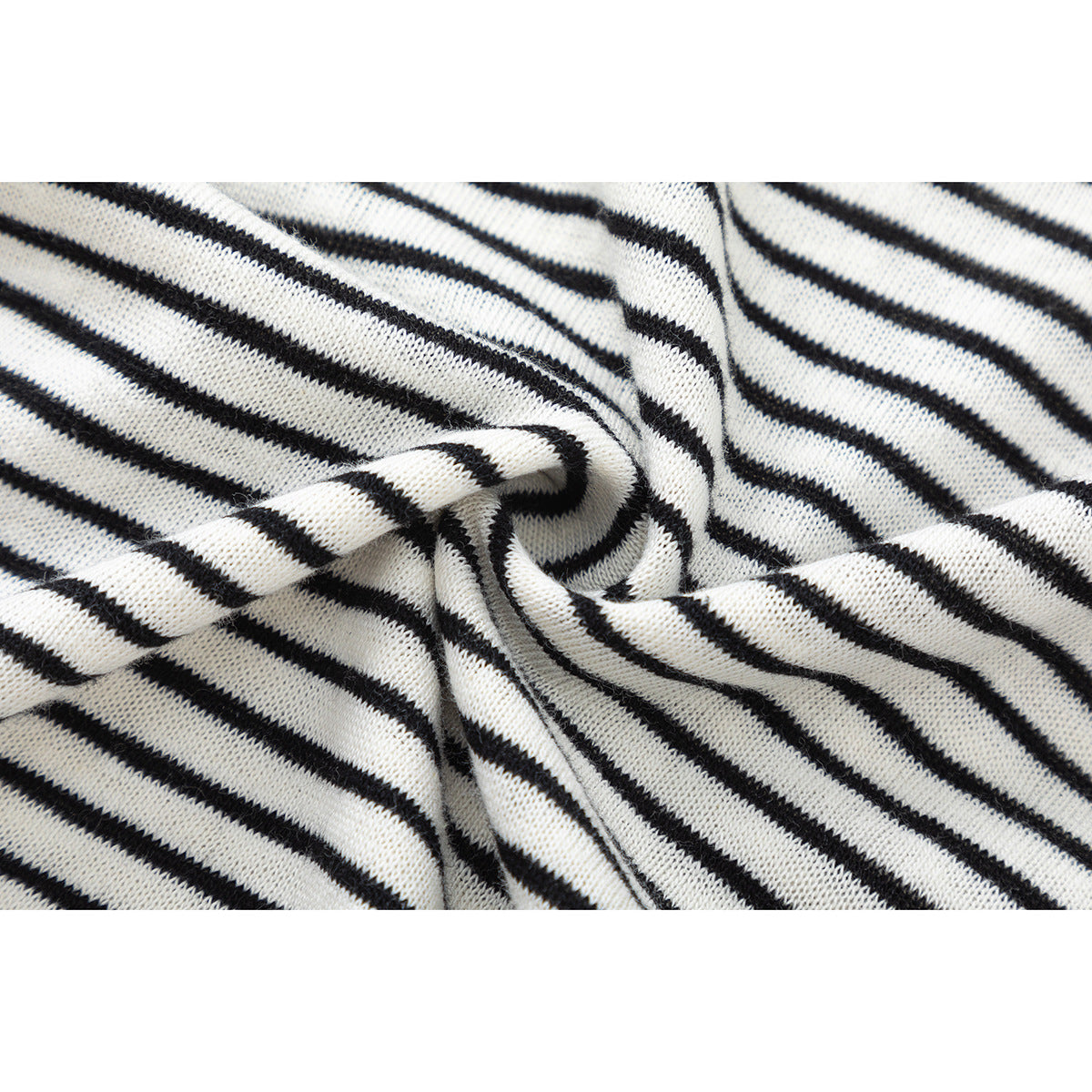 Close-up of black-and-white striped knit fabric gathered into a twist.