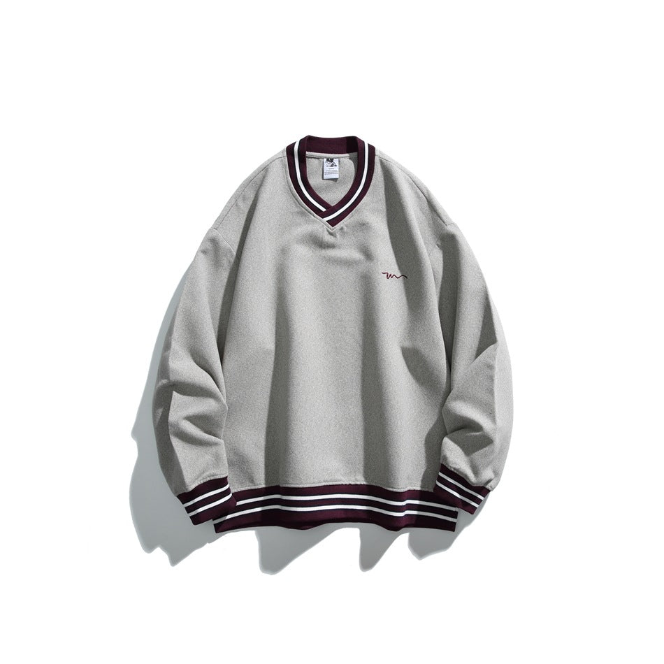 Gray V-neck sweatshirt with burgundy and white striped trim, flat lay with a small chest embroidery